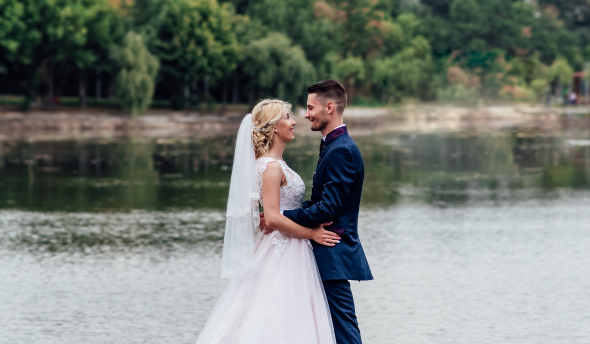 A couple getting married by a lake